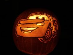 a pumpkin carved to look like the character from cars is lit up in the dark