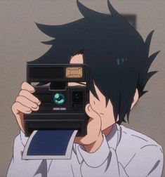 a man holding up a camera in front of his face