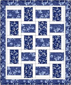 a blue and white quilt with flowers on it