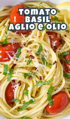 a white plate topped with spaghetti and tomatoes