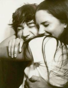 black and white photograph of two people hugging each other