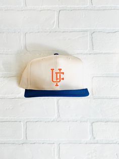 "University of Florida Gators Hat - (New) Cotton 6 Panel 2-Tone Hat Closure - Leather Strap with brass buckle Color - Cream/Royal Construction - 6 Panel Contents - 60% Cotton / 40% Polyester Profile - 3.25\" Size - One Size Fits All (6 ⅝\" - 7 ⅝\") Structure - Lightly Structured - Vintage Florida Gators Patch" Cute Florida Gator Outfits, Florida Gators Aesthetic, Nyc Hat, Braves Hat, Texas Rangers Hat, Atlanta Braves Hat, Ny Hat, Florida Gators Hoodie, Texas Baseball