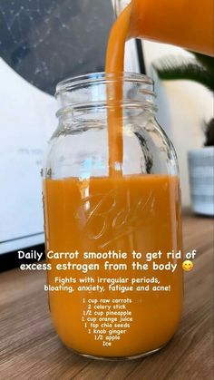 an orange juice is being poured into a mason jar with information about the smoothie