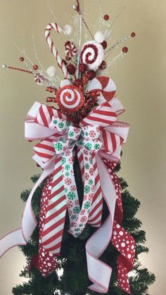 a christmas tree decorated with candy canes and bows