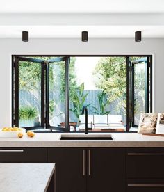 an open kitchen with sliding glass doors leading outside