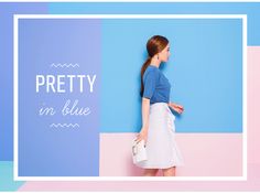 a woman standing in front of a blue and pink wall with the words pretty on it