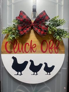 a sign with three chickens on it that says, chuck'o'clock and two red bows