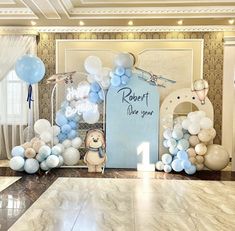 a room decorated with balloons and decorations for a baby's first birthday