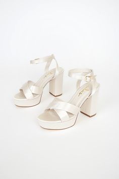 Lulus Exclusive! Kick your OOTN up a notch by slipping on the Lulus Selah Ivory Satin Ankle Strap Heels! Thick satin straps cross over a peep-toe upper, while an ankle strap wraps around ankle and secures with a gold buckle. 1"" toe platform. 4" wrapped block heel. Cushioned insole. Rubber sole has nonskid markings. Man made materials. Imported. Lulus | Selah Ivory Satin Ankle Strap Heels | Size 9. White Heels Aesthetic, Jennie Closet, Hoco Heels, Hoco Shoes, Ivy Shoes, Ivory Heels, Dr Shoes, Cute Shoes Heels, Heels Platform