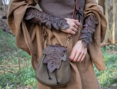 "Join the FOTW Realm and get an instant 10% off code! http://eepurl.com/hrobtv Blend into the forest with our Woodland Series leaf bracers! Perfect for the Fae folk, these soft leather arm guards are made with layers of oak leaves, in an earthy mix of greens or browns, choose at checkout. Shades of colors will vary greatly, pictures show examples only. ~~ Adult one size fits all, lace up ~~ Measurements: 8\" long ~ ~ ~ ~ ~ ~ ~ ~ ~ ~ ~ ~ ~ ~ ~ ~ ~ ~ ~ ~ ~ ~ ~ ~ ~ ~ ~ ~ ~ ~ ~ ~ ~ Medieval garb &am Into The Forest, Arm Guard, Leather Leaf, Drawstring Top, Oak Leaves, Fantasy Costumes, Belt Pouch, Womens Dress, Fantasy Clothing