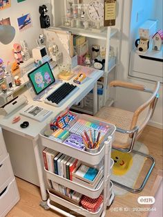 a desk with a laptop computer on top of it next to a book shelf filled with books