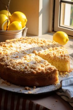 a cake on a plate with lemons in the background