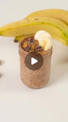 a banana sitting next to a jar of oatmeal with nuts and bananas