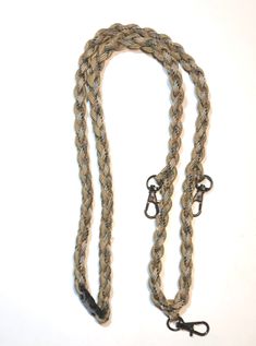 a brown rope with black handles on a white background