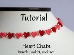 a red and white beaded necklace on a mannequin neckline with the words heart chain written below it