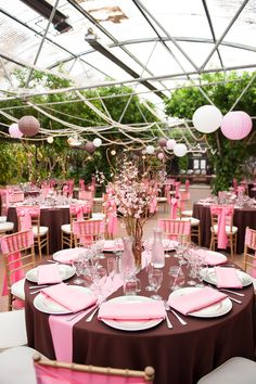 the tables are set with pink and white linens