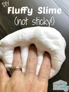 a person holding a doughnut in their hand with the words diy fluffy slime not sticky on it