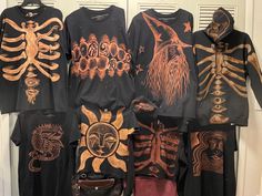 a group of shirts that are hanging up on a door sill with skeleton designs