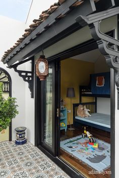 an open door to a bedroom with a bed in the corner and a rug on the floor