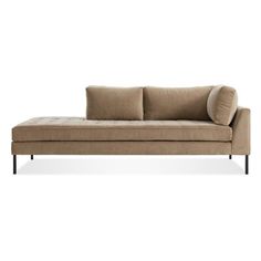 a tan couch with two pillows on the back and one arm folded up to it's left side