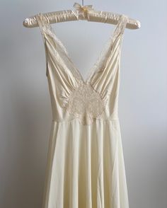 a white dress hanging on a hanger