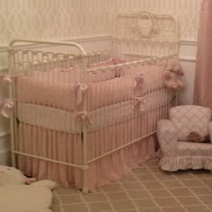 a baby's room with two cribs, a chair and a teddy bear