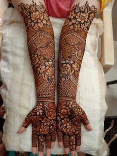 two hands with henna designs on them