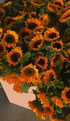 a large bouquet of sunflowers sitting on top of a table