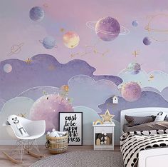 a child's bedroom decorated in pastel colors with planets painted on the wall