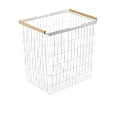 a white wire basket with wooden handles