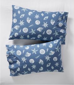 two blue pillows with shells and starfish on them