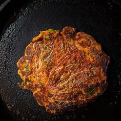 an omelet is being cooked in a skillet