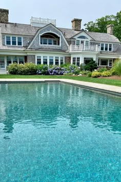 a large house with a pool in front of it