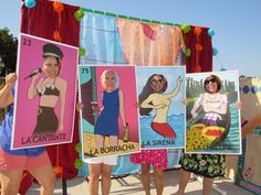 three women holding up posters in front of them