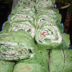 rolled up food items sitting on top of a blue tray