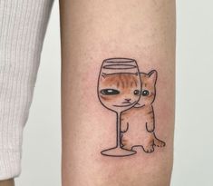 a cat with a wine glass tattoo on its leg