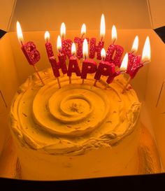 a birthday cake with candles that spell happy