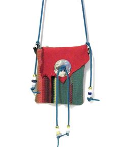 a red and green purse hanging from a wall