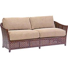 a wicker couch with two pillows on it's back and seat cushions upholstered