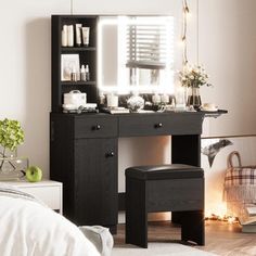 a bedroom with a desk, mirror and stool next to a bed in the room