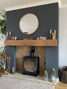 a living room with a fire place and mirror on the wall