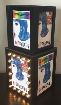 two lighted cubes that have hair products on top of each other, with the words hairspray in front of them