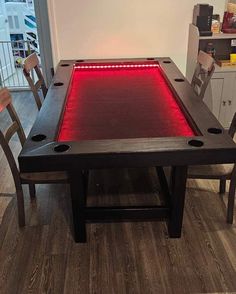 a table with red lights on it in the middle of a room filled with chairs