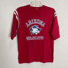 an arizona wildcats shirt hanging on a wall