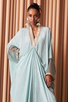 Blue full sleeves high low draped kaftan in crepe base with sequin trim lace embellished neckline and sheer detailing on the sleeves. Components: 1 Pattern: Embroidery Type Of Work: Sequin Trim Lace Neckline: V Neck Sleeve Type: Full Fabric: Crepe Color: Blue Occasion: Sangeet, Mehendi and Haldi - Aza Fashions Draped Kaftan, Sheer Kaftan, Summer Court, Kaftan Women, Kaftan For Women, Birds Embroidery Designs, Embellished Neckline