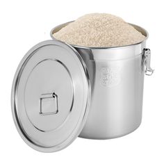 a large metal pot filled with rice on top of a white background, next to an open lid