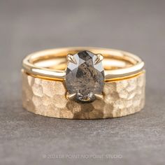 two gold wedding bands with a large brown diamond in the center and a smaller one on each side