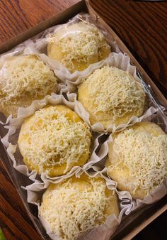 six pastries in a box on a table