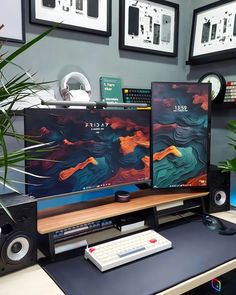 two computer monitors sitting on top of a desk