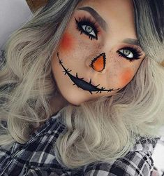 a woman with grey hair and makeup wearing a pumpkin face paint